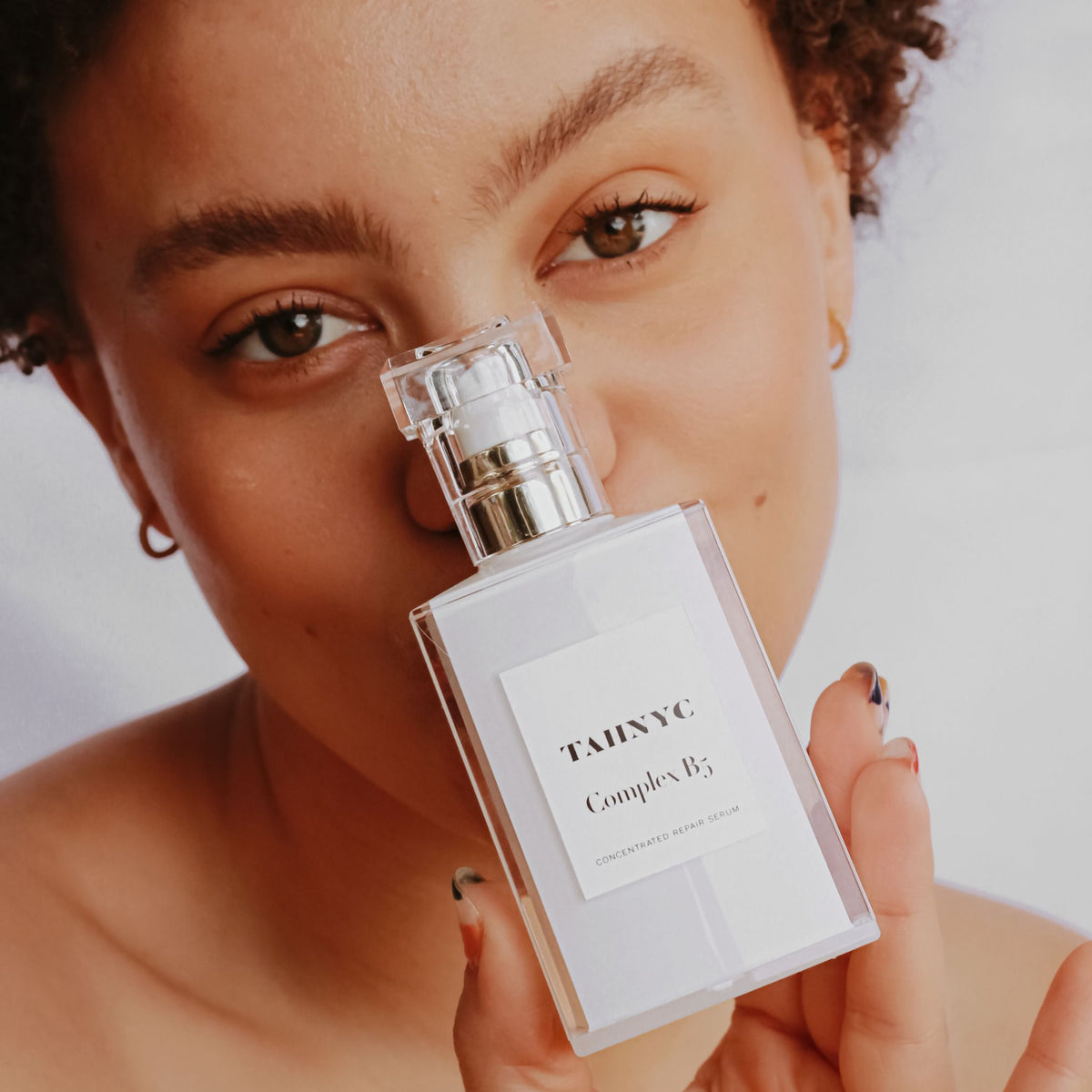 Tahnyc Complex B5 Concentrated Repair Serum on Face as Backdrop | Canada