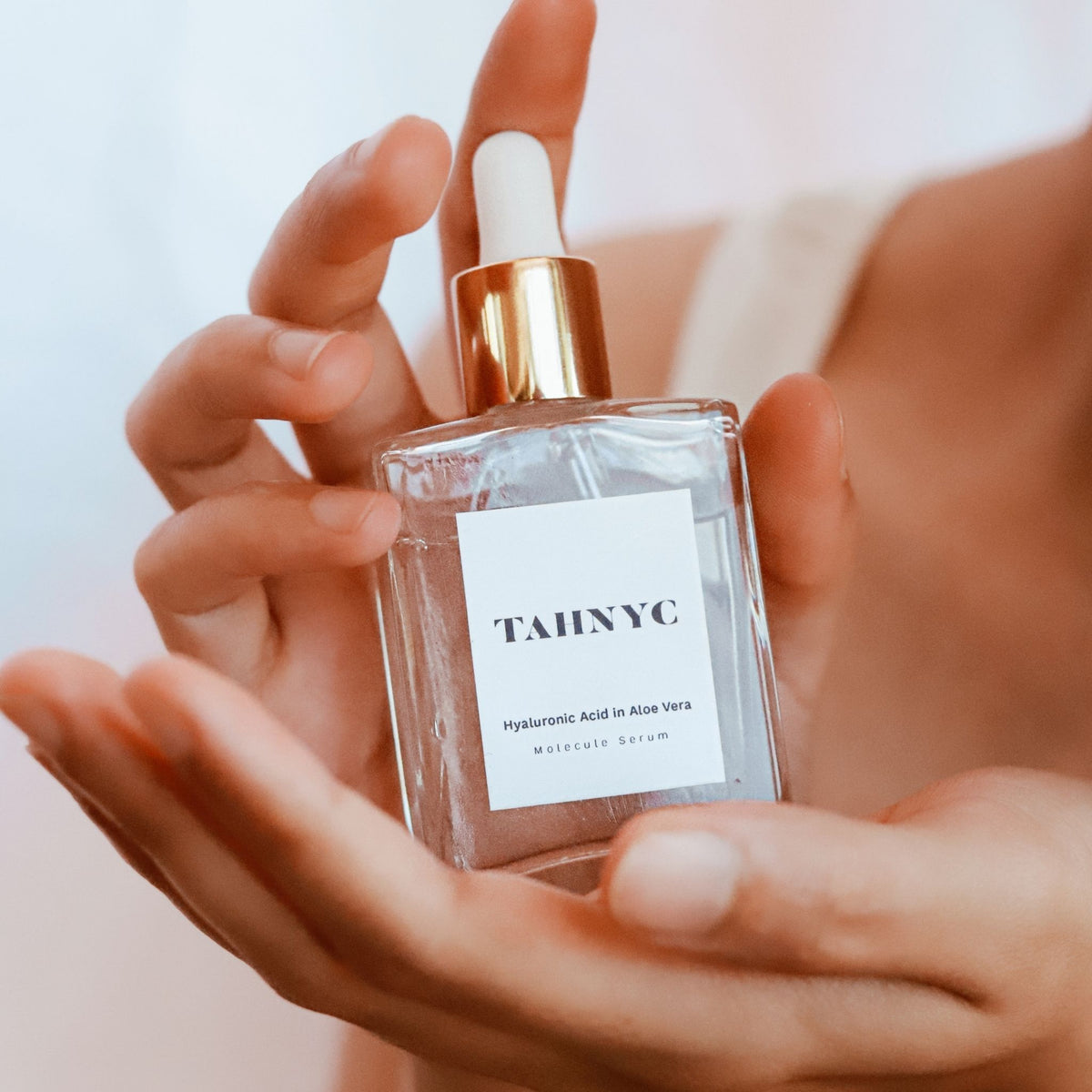 Vegan Hyaluronic Acid in Aloe Vera Molecule Serum held in both hands, 100% clean, filler-free.